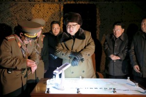 North Korean leader Kim Jong Un talks with officials at the ballistic rocket launch drill of the Strategic Force of the Korean People's Army (KPA) at an unknown location, in this undated photo released by North Korea's Korean Central News Agency (KCNA) in Pyongyang on March 11, 2016.  REUTERS/KCNA