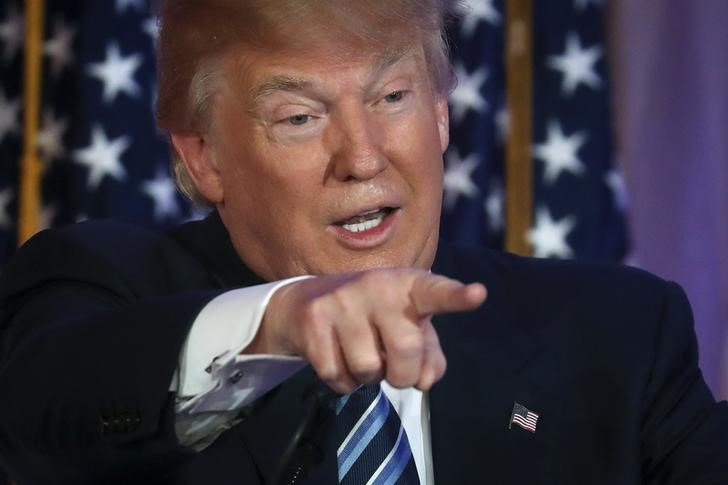 Republican U.S. presidential candidate Donald Trump speaks to the media after receiving former Republican presidential candidate Ben Carson's endorsement at a campaign event in Palm Beach