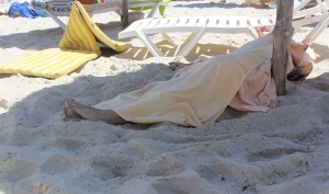 ATTENTION EDITORS - VISUAL COVERAGE OF SCENES OF DEATH AND INJURY  The body of a tourist shot dead by a gunman lies near a beachside hotel in Sousse, Tunisia June 26, 2015. At least 27 people, including foreign tourists, were killed when at least one gunman opened fire on the Tunisian beachside hotel in the popular resort of Sousse on Friday, an interior ministry spokesman said. Police were still clearing the area around the Imperial Marhaba hotel and the body of one gunman lay at the scene with a Kalashnikov assault rifle after he was shot in an exchange of gunfire, a security source at the scene said. REUTERS/Amine Ben Aziza