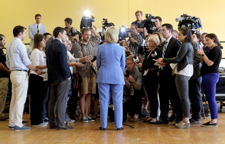 Democratic presidential candidate Clinton answers questions from reporters following a campaign town hall meeting in Dover