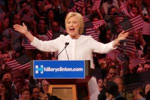 Clinton claims nomination as primaries near end