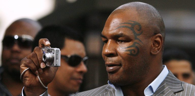 File photo of Mike Tyson taking a picture as he arrives at the premiere of "Resurrecting the Champ" at the Samuel Goldwyn theatre in Beverly Hills