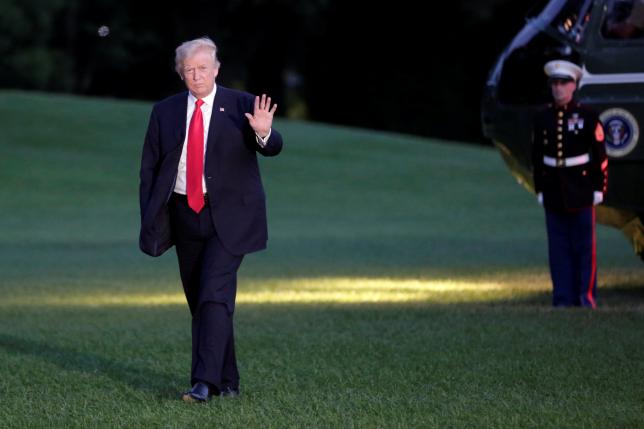 President Donald Trump waves as walks on the South Lawn