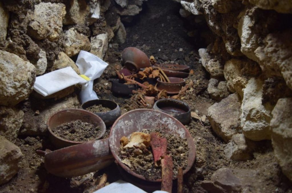 Burial 80 during excavation shows stone cup in the center surrounded by bones.