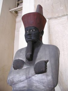 Mentuhotep II: Painted sandstone seated statue of Nebhepetre Mentuhotep II