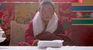 Padma Angdu sits on a throne and awaits veneration from elder followers