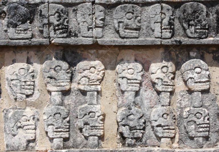 Bas-relief carving with human skulls on Tzompantli , Chichen Itz