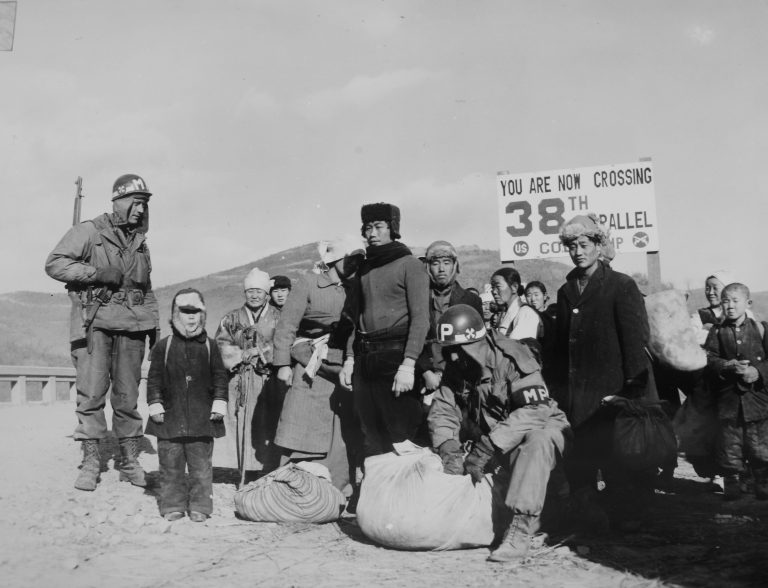 Refugees checked at 38th Parallel for contraband before allowing them to cross the 38th Parallel bridge during the Korean War.