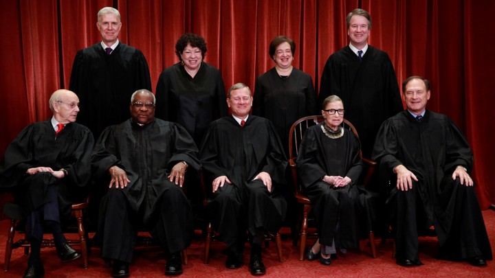 U.S. Supreme Court justices pose for group portrait at the Supreme Court in Washington