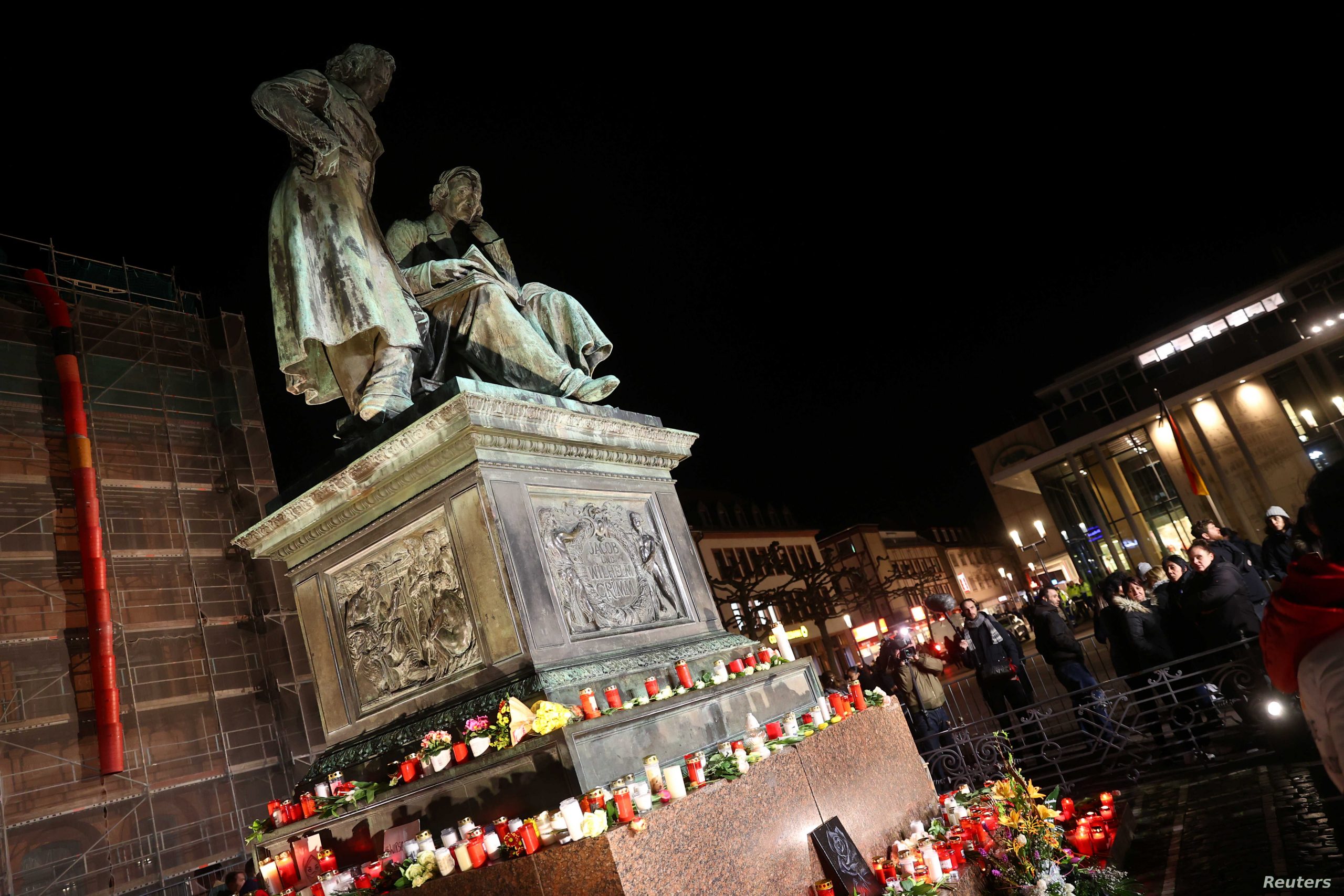 People attend a vigil for the victims of a shooting in Hanau