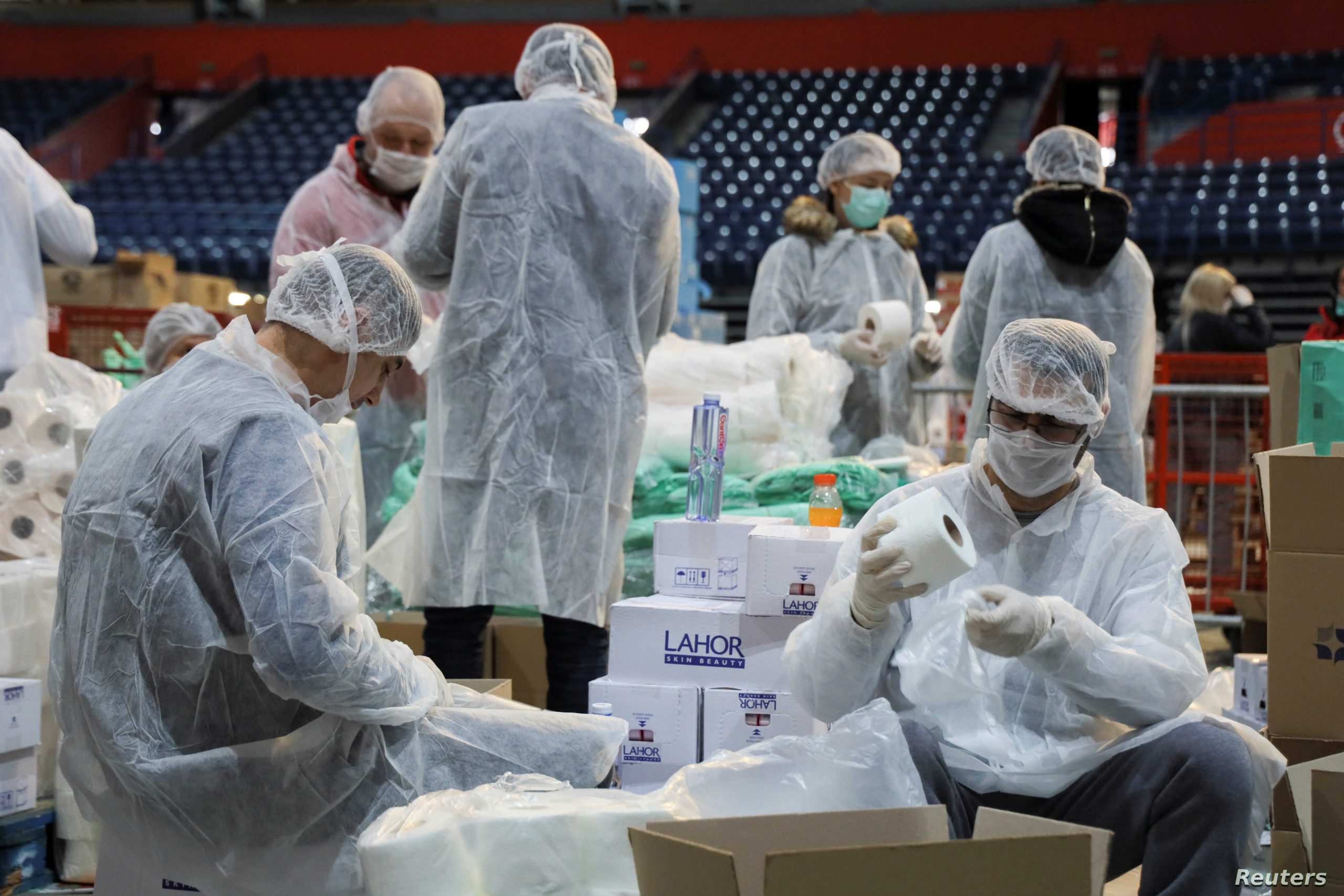 Volunteers help pack boxes of donated aid for elderly people who are banned from leaving their homes because of the coronavirus disease (COVID-19) epidemic in Belgrade