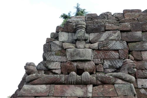 The Ascending Terraces of Sukuh, a Mountain Buddhist Sanctuary 27 The bird Garuda, whose both wings open but face is already damaged, claws two nagas of which bodies were wrapped around each other, Sukuh, Java, 15th century