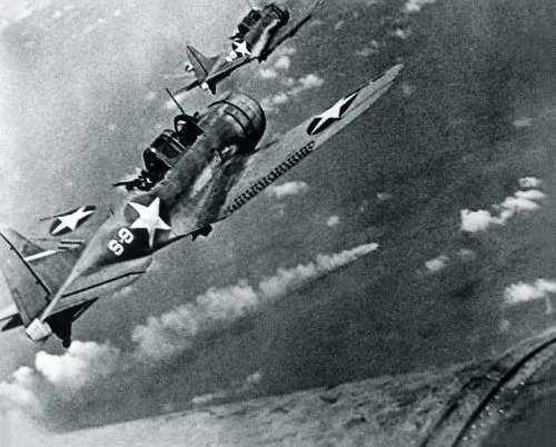 U.S. Douglas SBD-3 Dauntless dive bombers of VS-8 from USS Hornet about to attack the burning Japanese cruiser Mikuma for the third time on 6 June 1942