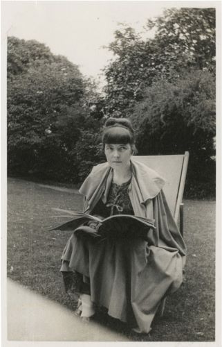 Photograph by Lady Ottoline Morrell of Katherine Mansfield reading in the gardens of Garsington Manor, ca. 1917