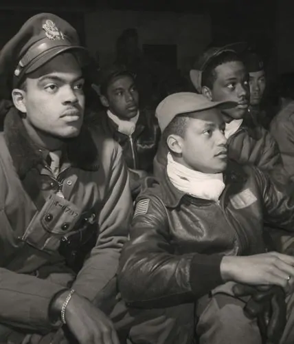 Tuskegee Airmen of the 332nd Fighter Group, United States Army Air Forces (USAAF), attend a briefing at Ramitelli Airfield, Italy in March 1945