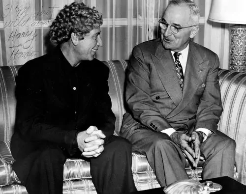 Harpo Marx and President Truman chat at Fairfield-Suisun Air Force Base in California, 