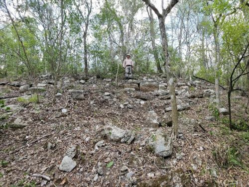 Using Science to Laser in on an Ancient Monumental Mayan City 7 A researcher stands upon the remains of what archaeologists believe was an acropolis-type structure in the Maya city of Ocomtun