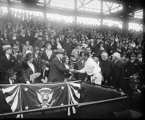 Lou Hoover and Herbert Hoover shaking hands with Walter Johnson at a baseball game. Harris & Ewing, 1931
