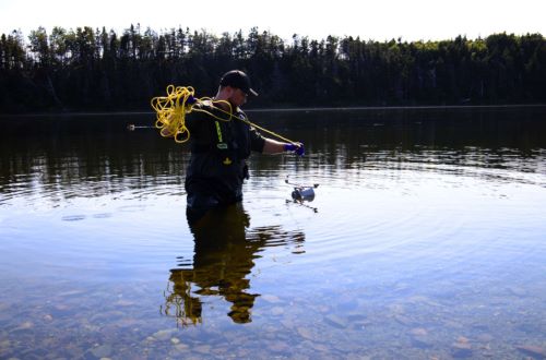 Ecologist Alistair Wallace of eDNAtec demonstrates how to collect a sediment sample optimized for eDNA analysis on the Manuels River in Canada