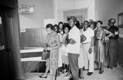 Black citizens wait in line at the Holmes County Circuit Clerk’s office in Lexington, Miss.