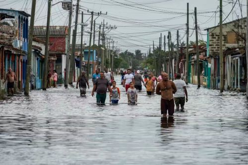 Huracan: A Storm God of the Ancient Maya 16 Residents wade through a street flooded by Hurricane Helene, in Batabano, Mayabeque province, Cuba, on Sept. 26, 2024