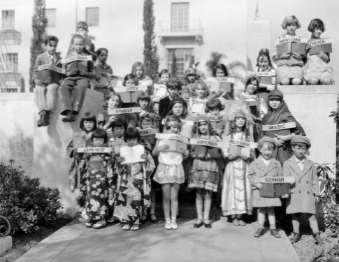 A History of Public Libraries in the United States from the 18th Century 51 Children dressed in the costumes of many different countries hold signs indicating the languages in which books are available at the Los Angeles Public Library, 1939