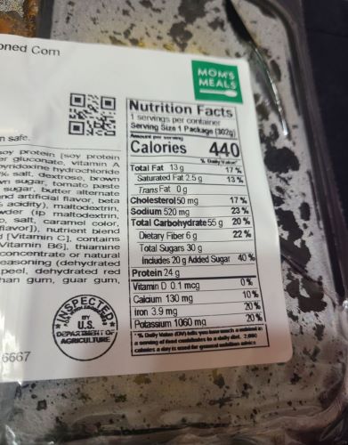 Packaging showing 30 g of sugar (20 g added) in a meal from Mom's Foods