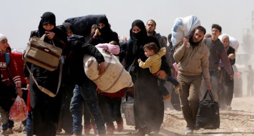 People walk with their belongings as they flee the rebel-held town of Hammouriyeh, eastern Ghouta, Syria