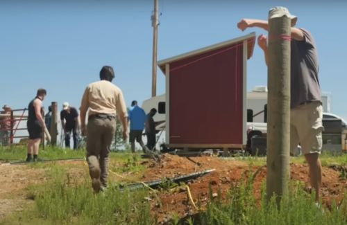 Fertile Ground for Division: Inside the 'Return to the Land' Movement in Rural Arkansas 7 A man working on a pole