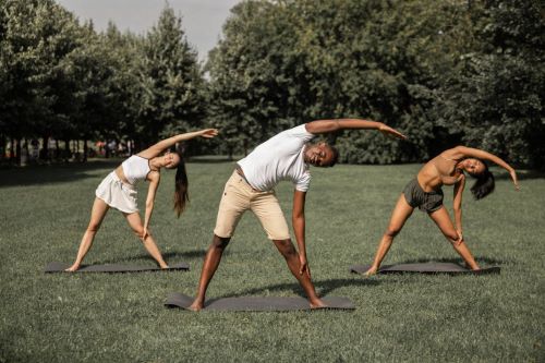 A group of people exercising in a park.