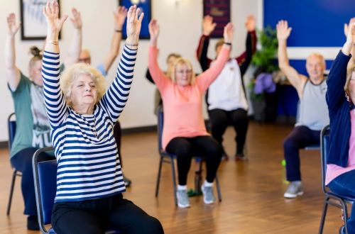 Senior citizens performing a fitness routine.