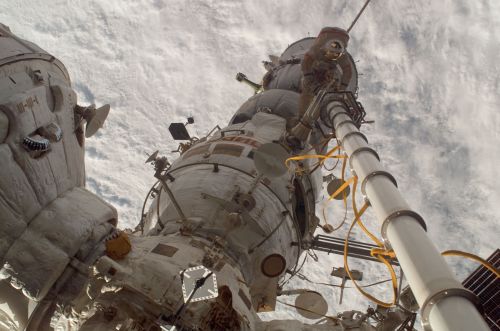 A Quieter Orbit: NASA’s Retreat from a Permanent Space Station Future 8 Commander Volkov stands on Pirs with his back to the Soyuz whilst operating the manual
Strela crane