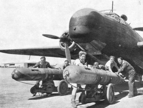 Loading aerial torpedoes into a Type 429 Mark VIII Vickers Wellington maritime patrol aircraft, May 1942