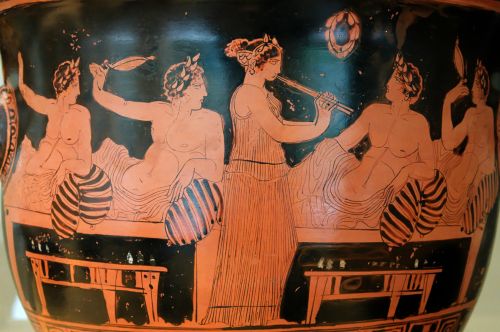The Deipnosophistes belongs to the literary tradition inspired by the use of the Greek banquet. Banqueters playing Kottabos while a musician plays the Aulos, decorated by the artist 'Nicias'/'Nikias'.