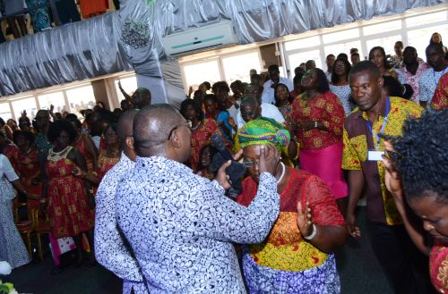 Example of laying on of hands during a service in Ghana