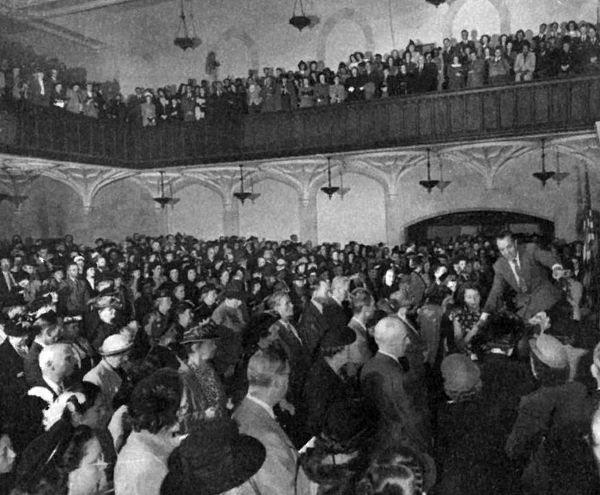 Evangelical broadcaster William Ward Ayer (far right), who would later become the first president of the National Religious Broadcasters, stands before a congregation during an altar call at New York's Calvary Baptist Church