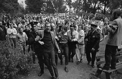 R. G. Davis and other Troupe members arrested, 1965, for performing in park without a permit