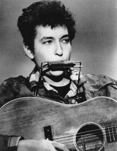 Bob Dylan, 1963, wearing a harmonica holder