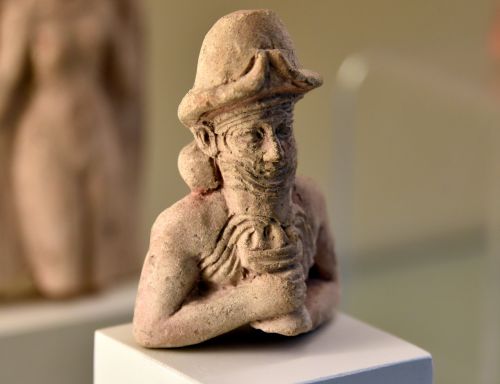 Ea (also Enki), deity of music, wears a horned helmet and holds a cup from which water overflows