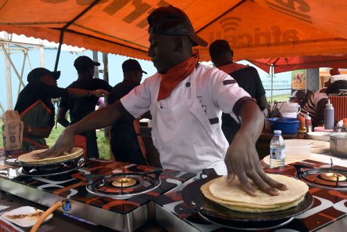 Rolling History: Roti, Women’s Labor, and the Flatbread That Connected Worlds 8 At a festival in Kampala, Uganda, a cook prepares a popular local dish called “rolex”