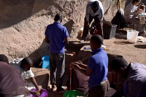 Excavators standing at the depth of the pyre at the Hora 1 site in northern Malawi