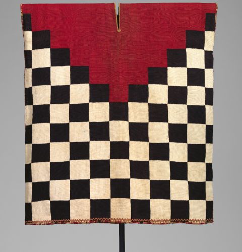 Qhapaq Ñan: The Inka Road Network That Made an Empire 8 An Inca standard military tunic made of black and white checks and a red triangle below the neck
