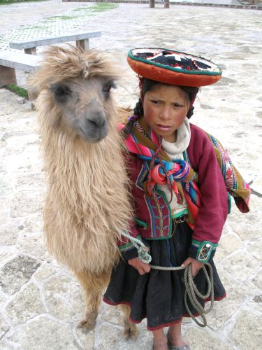 Qhapaq Ñan: The Inka Road Network That Made an Empire 11 A Quechua girl in traditional dress with a llama in Cusco, Peru