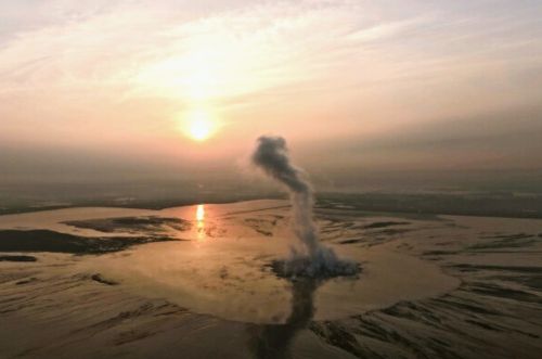 Smoke billows from the crater of the "mud volcano" that was caused by a gas exploration accident in 2006, in Sidoarjo, East Java, Indonesia