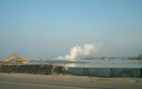 Gas plumes next to excavators working in Sidoarjo