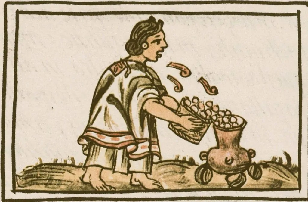 Aztec woman blowing on maize (corn) before putting it into the cooking pot so it will not fear the fire