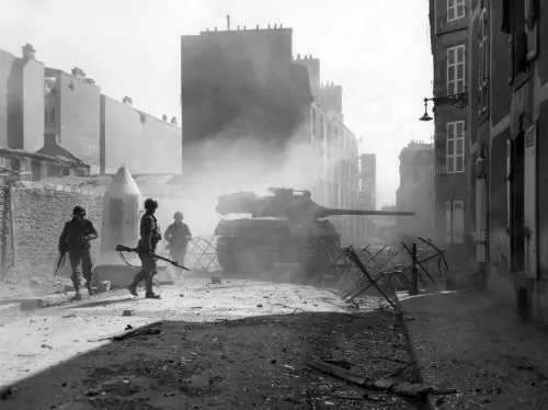 Mythology and the Two World Wars: From Ancient Heroes to Nazi Racial Myth 2 United States Army infantry supported by a M18 tank destroyer advancing through a German-occupied Brest, France, during World War II