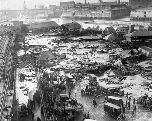 Molasses Mayhem: Boston’s Great Syrupy Flood of 1919 2 The wreckage of the collapsed molasses tank is visible in the background, center, next to the light-colored warehouse