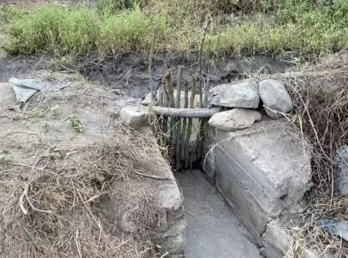 A handmade gate on a modern canal in northern Peru