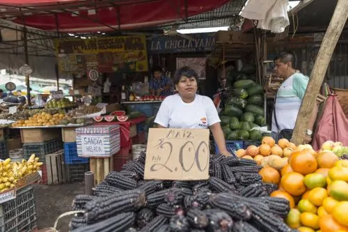 Farmers sell locally grown corn and other crops at a street market in Piura, Peru
